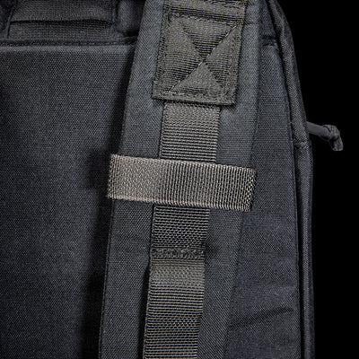 Close-up of the Bullet Ruck USA Throwback's black strap featuring CORDURA construction and a stitched loop, set against a dark background.