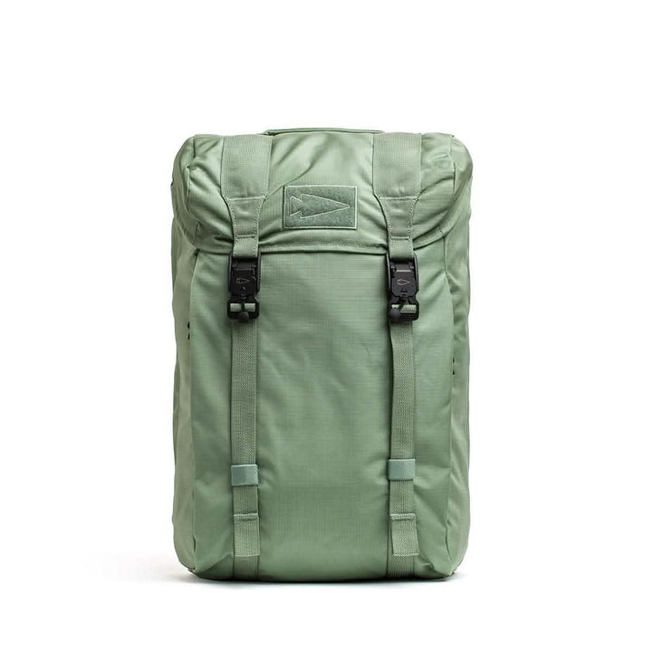 The M23 - Ripstop ROBIC® by GORUCK, in Seaspray and Speed Tan, showcases a top flap design with two black buckles on the front and a stitched rectangular patch. Crafted from durable materials, this field pack stands upright against a plain white background.