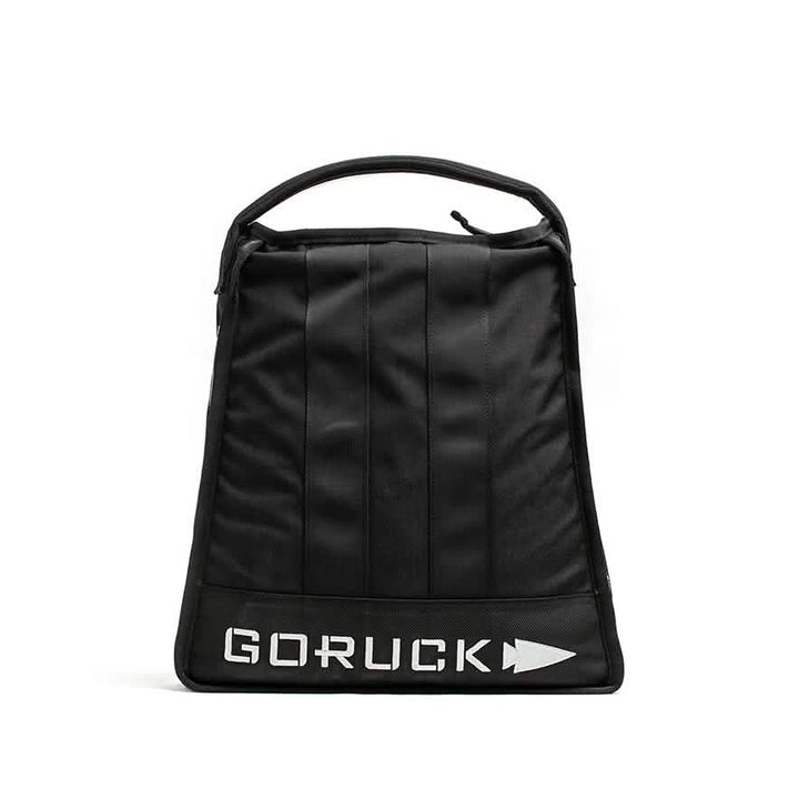 A GORUCK Sand Jerry Can in black stands upright, highlighting its minimalist design and vertical stitching with a sturdy handle. Crafted from Special Forces Grade materials, the bag prominently displays the GORUCK logo in bold white letters at the bottom, while a plain white background accentuates its robust structure.