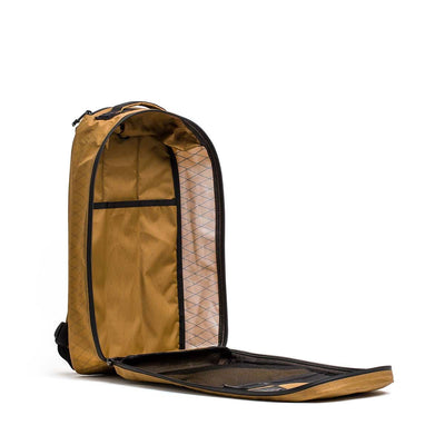 The Bullet X-PAC brown daypack, crafted from durable X-PAC fabric, stands upright with its front flap wide open, fully unzipped to display its inner pockets and compartments.