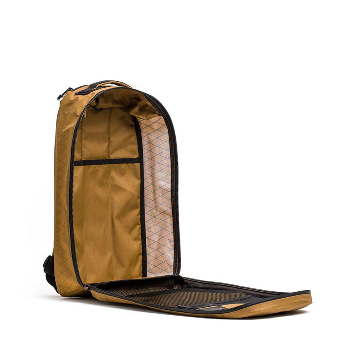 The Bullet X-PAC brown daypack, crafted from durable X-PAC fabric, stands upright with its front flap wide open, fully unzipped to display its inner pockets and compartments.