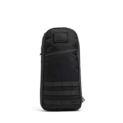 The Bullet Ruck USA Throwback is a black tactical sling bag made with durable CORDURA, featuring a front zipper pocket, MOLLE webbing, and a top-front patch—ideal as a compact daypack.