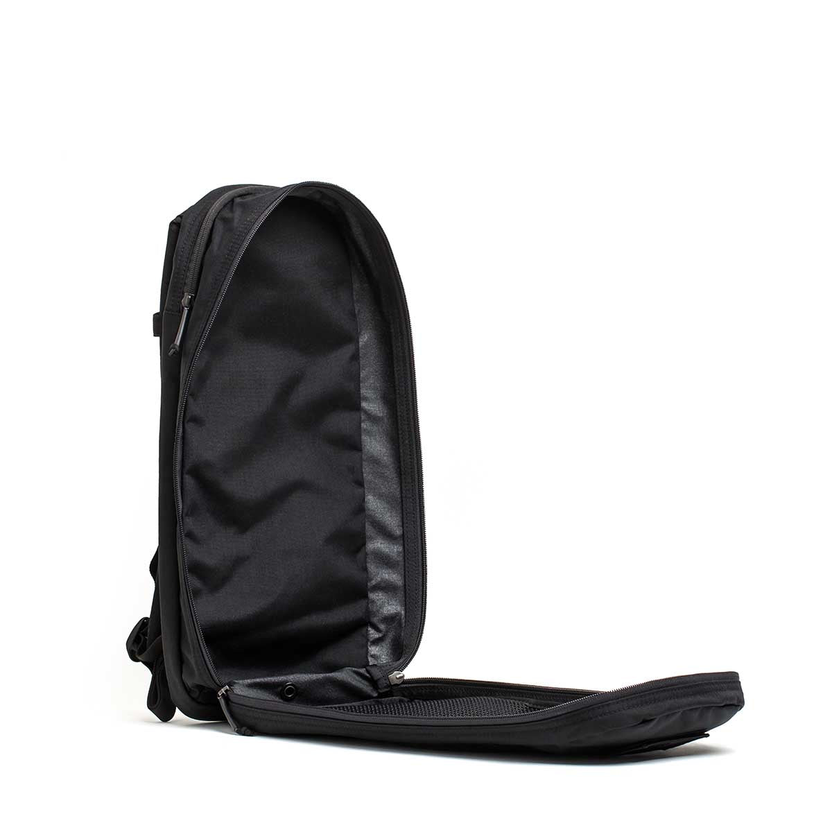 The Bullet Ruck USA Throwback daypack is shown open with its front flap unzipped, revealing an empty main compartment and durable CORDURA construction.