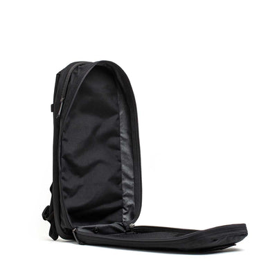 The Bullet Ruck USA Throwback daypack is shown open with its front flap unzipped, revealing an empty main compartment and durable CORDURA construction.