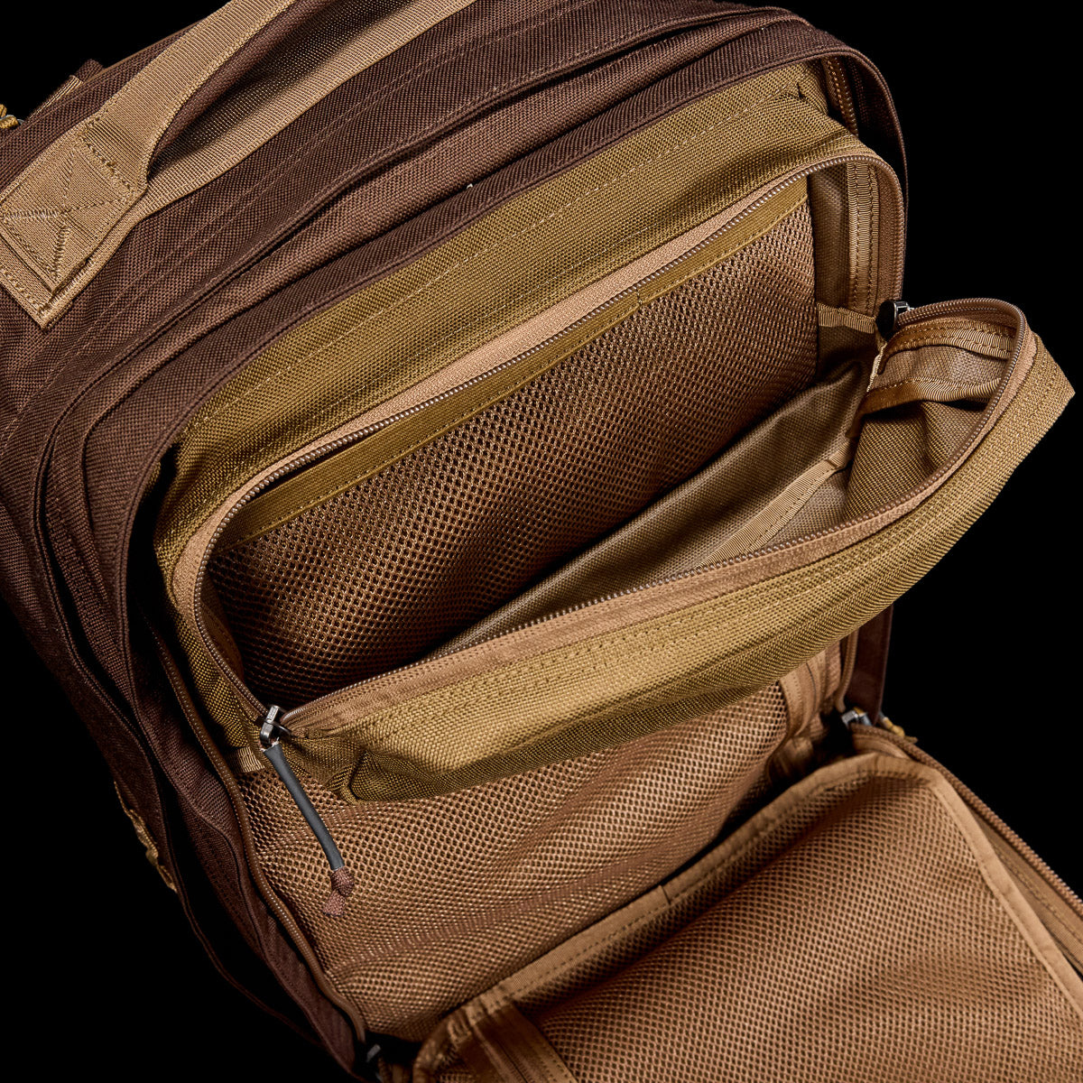 The GR2 - Ballistic Nylon Cordura, shown from above in brown, features multiple unzipped compartments and mesh pockets—making it a perfect carry-on compliant travel ruck.