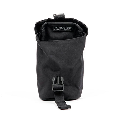 A black, cylindrical GORUCK Full Panel Water Bottle Pocket with a buckle strap. Inside, there's a label stating it's Built in Vietnam. It includes a MOLLE attachment system for customizable carry options and is open to display its spacious interior, ideal for organizing essentials.