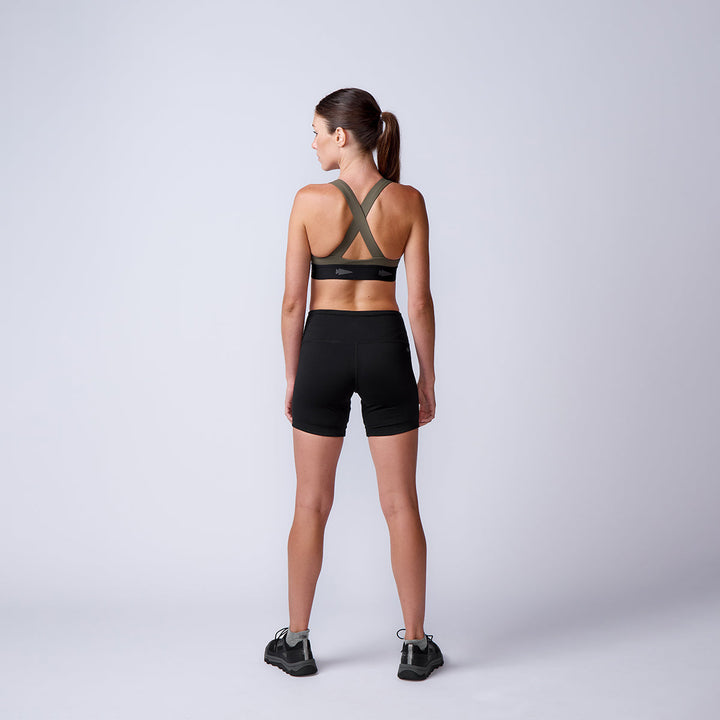 Woman wears ToughFlex Women’s Biker Shorts and sneakers, standing with her back to the camera against a plain light gray background.