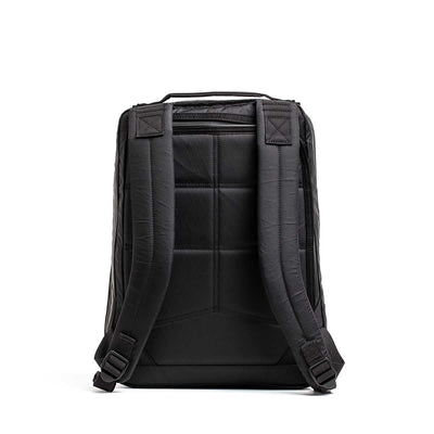 The GR0 - X-PAC is a black, lightweight rucksack shown from the back, featuring padded shoulder straps, a cushioned back panel, and tough waterproof X-Pac material.