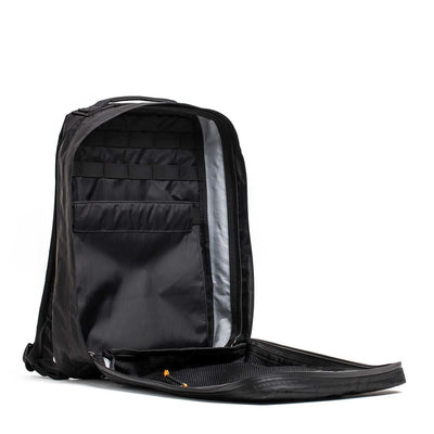 The GR0 - X-PAC is a black, lightweight rucksack, fully unzipped to reveal organized inner compartments, a spacious main section, and durable waterproof X-PAC material.