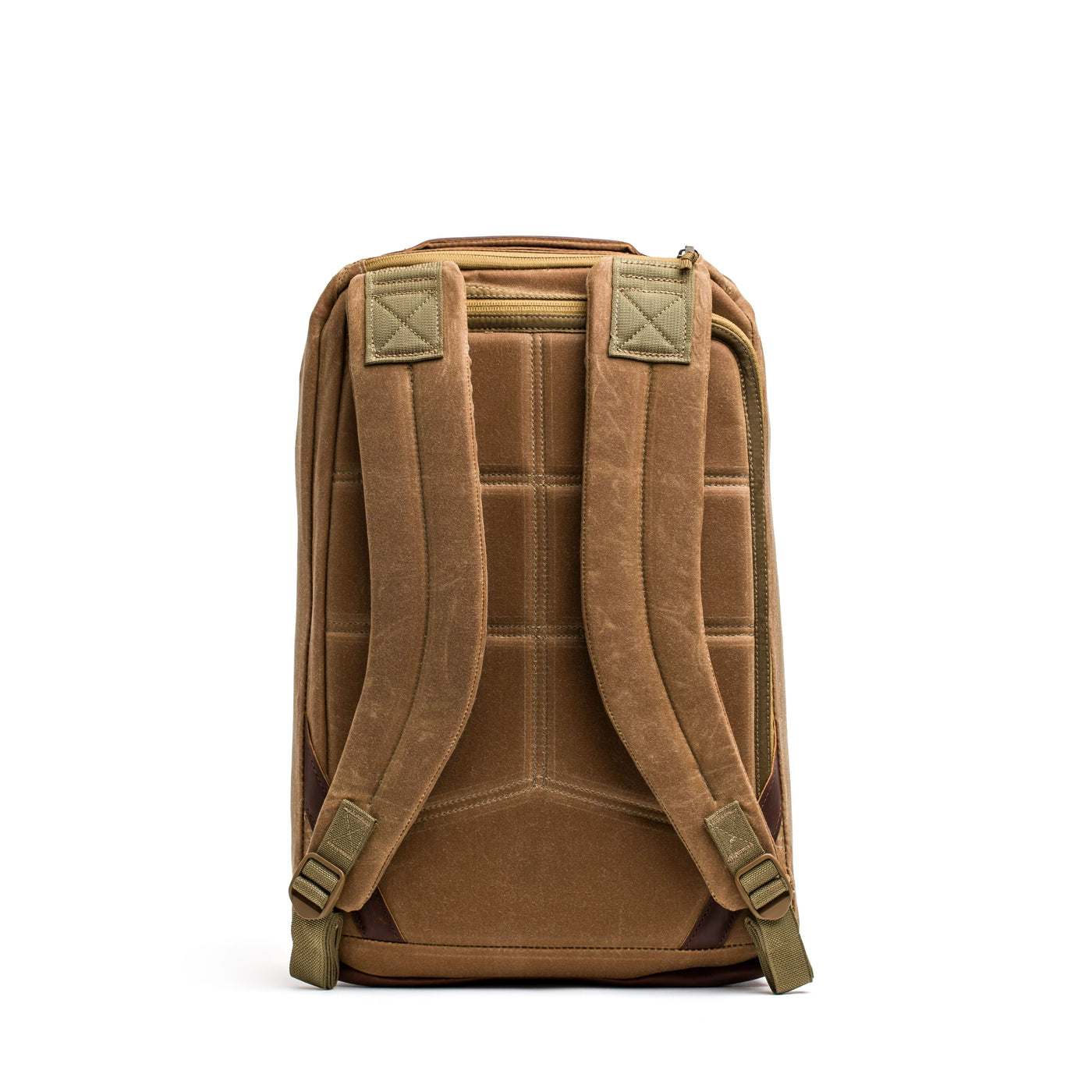 The GR1 USA - Heritage backpack by GORUCK, made from waxed duck canvas with padded straps and a top handle, stands upright against a white background, showcasing the charm of a classic rucksack.