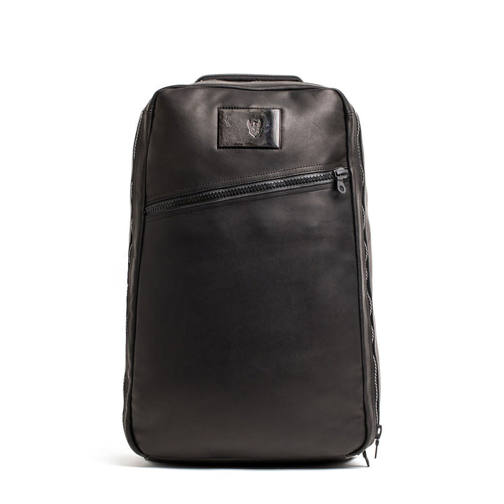 The GR1 USA x Carryology - Berserker Viking is a sleek black leather backpack featuring a diagonal front zipper and a small rectangular patch near the top, inspired by the bold spirit of Viking warriors.