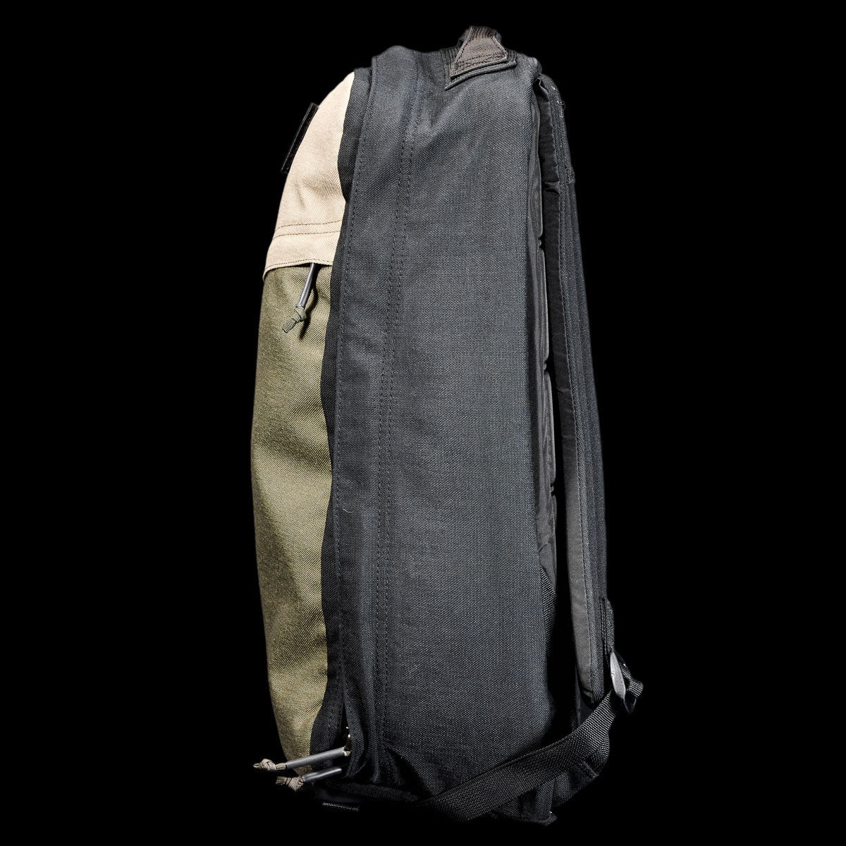 Side view of the GR1 Shooter 26L - Built by SCARS, showing black, green, and tan CORDURA® panels against a black background—engineered for durability by the SCARS team.