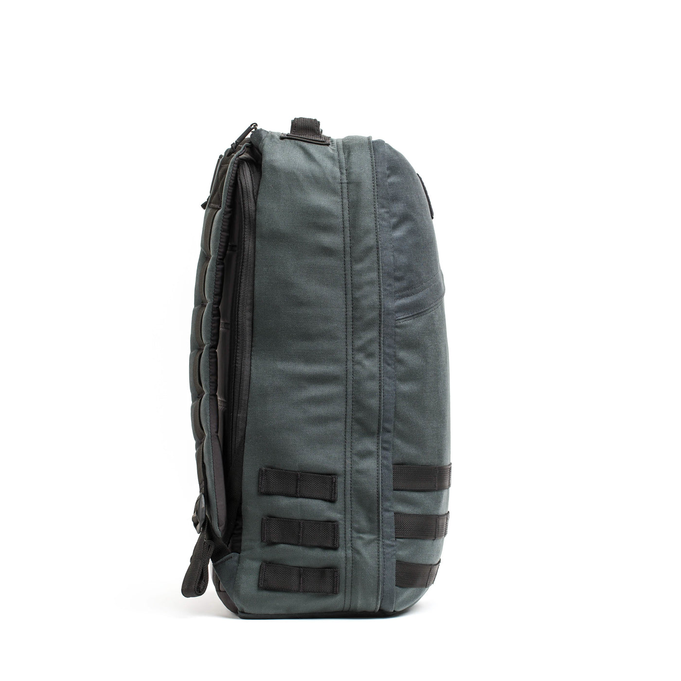 Here is a rewritten version of the sentence using the product data:

Side view of a dark gray GORUCK GR1 USA - Cordura backpack with padded straps, inspired by Special Forces requirements. It includes multiple compartments and black attachment loops on the side, standing upright against a plain white background.