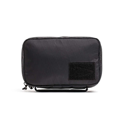 The GR1 Field Pocket - X-PAC is a rectangular black electronics organizer made from waterproof X-PAC fabric, with AquaGuard zippers and a front patch, displayed on a white background.