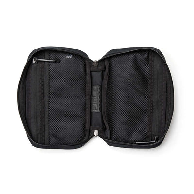 The GR1 Field Pocket - Waxed Canvas travel pouch is shown unzipped, revealing two mesh compartments and small interior pockets.