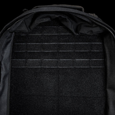 The open, empty GR1 Shooter 26L - Built by SCARS backpack features a velcro-lined interior with horizontal attachment strips, made from Special Forces Grade CORDURA®—perfect for any mission.