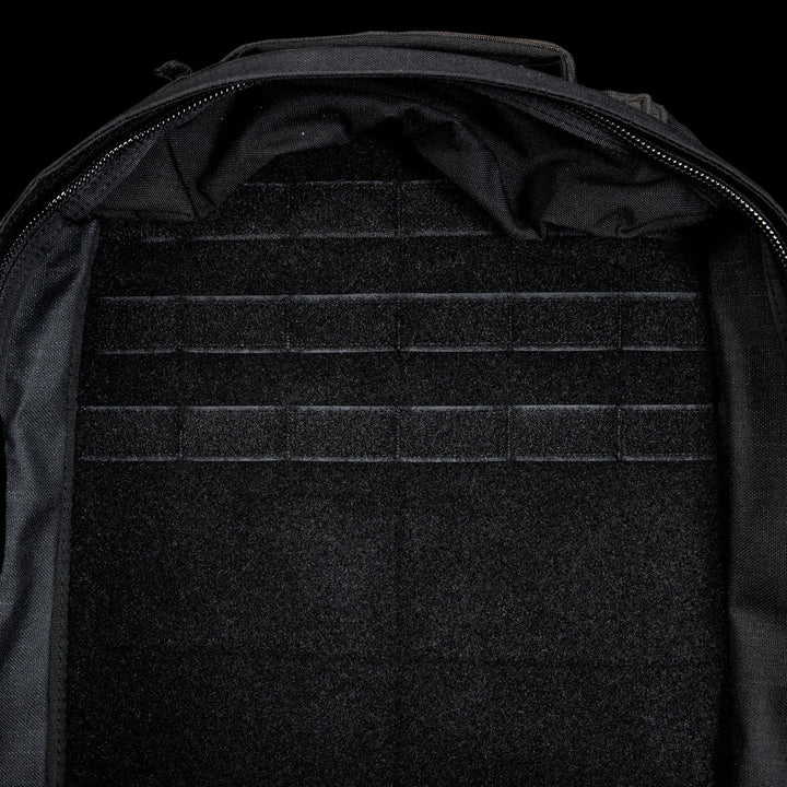 The open, empty GR1 Shooter 26L - Built by SCARS backpack features a velcro-lined interior with horizontal attachment strips, made from Special Forces Grade CORDURA®—perfect for any mission.