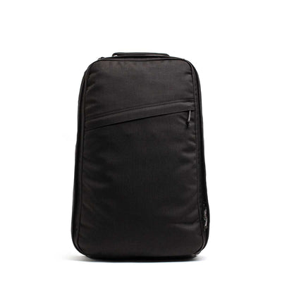 The GR1 USA Slick backpack in Ballistic Nylon Cordura, shown upright on a white background, features a sleek black design with Special Forces-grade quality and a front diagonal zipper pocket.