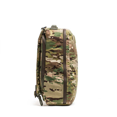 A side view of the GR1 USA - X-PAC backpack shows its durable, camouflage-patterned design with multiple waterproof zippers.