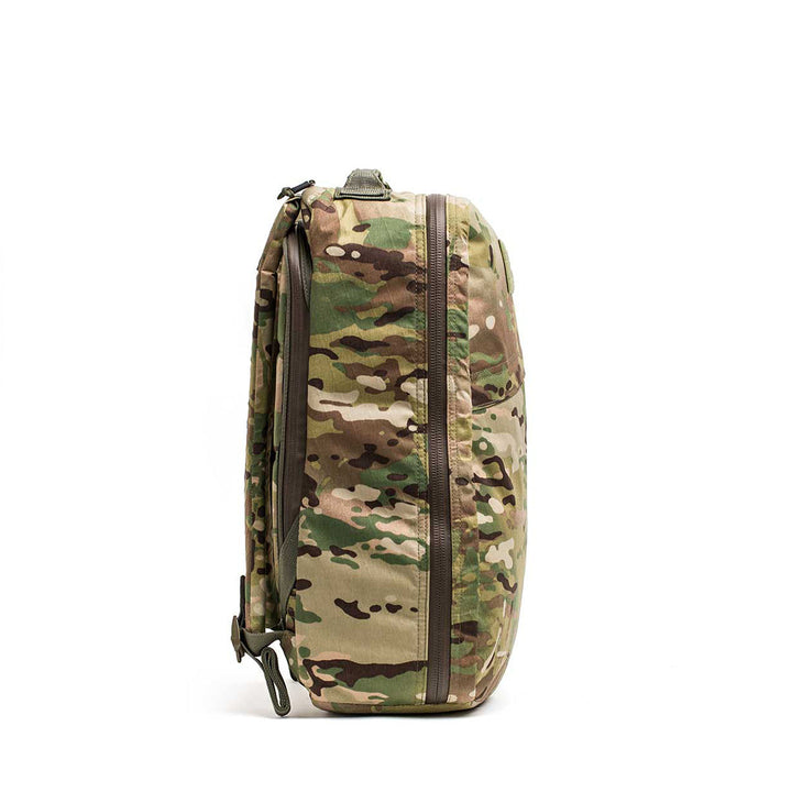 A side view of the GR1 USA - X-PAC backpack shows its durable, camouflage-patterned design with multiple waterproof zippers.