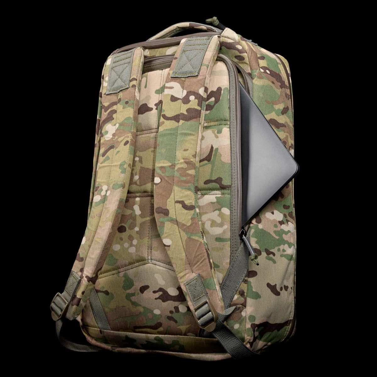 The GR1 USA - X-PAC backpack offers a lightweight, waterproof camouflage design with a visible laptop compartment against a black background.