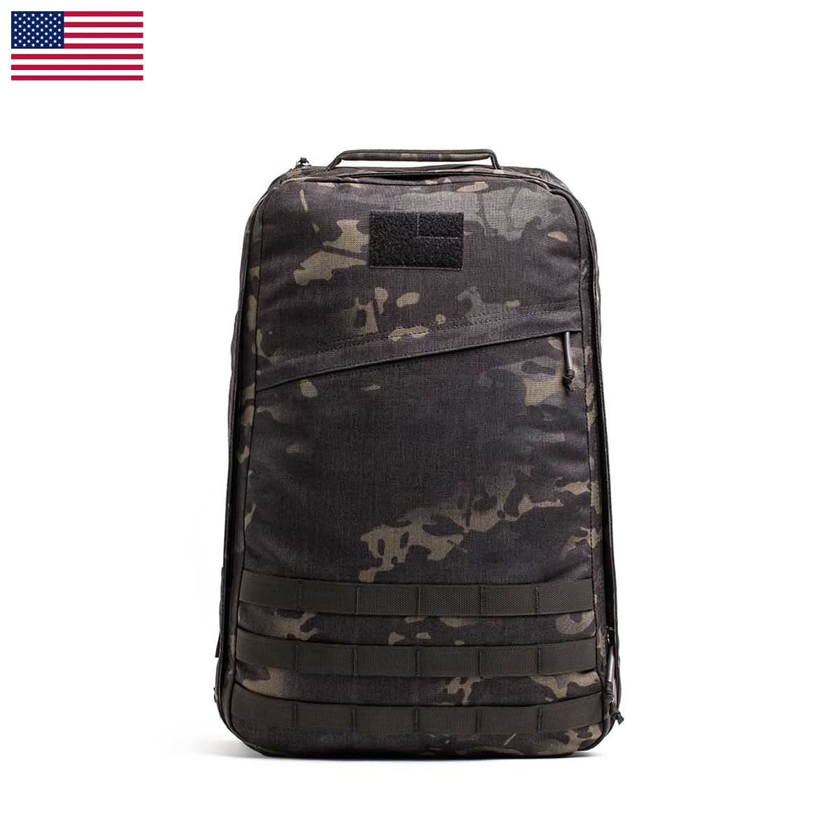 The GR1 USA - Cordura (The Original Ruck) backpack, in black and grey camouflage with a top handle, made from Special Forces-grade materials, is displayed against a white background with a US flag in the corner.