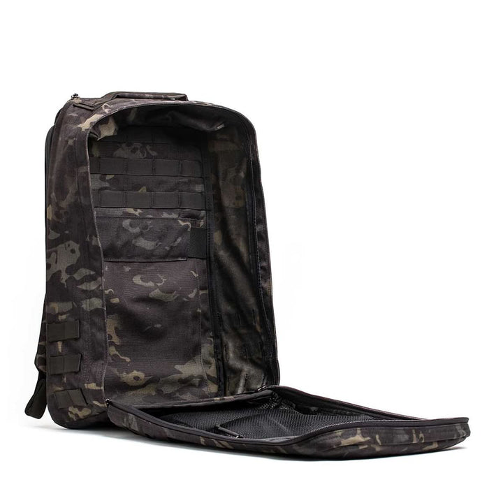 The GR1 USA - Cordura (The Original Ruck) is a black camo backpack made with Special Forces-grade materials, featuring a spacious interior with well-designed pockets and compartments—ideal for the GORUCK Challenge.