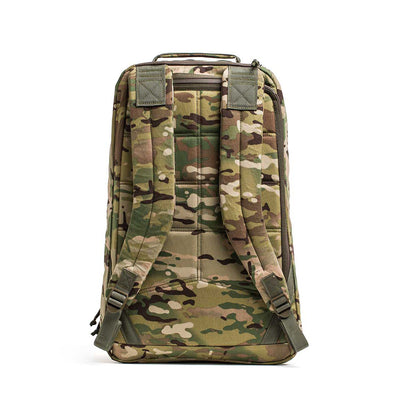 The GR1 USA - X-PAC rucksack comes in camouflage colors like green and brown. Designed for versatility, it features a waterproof fabric, dual shoulder straps, and a top handle for easy carrying.