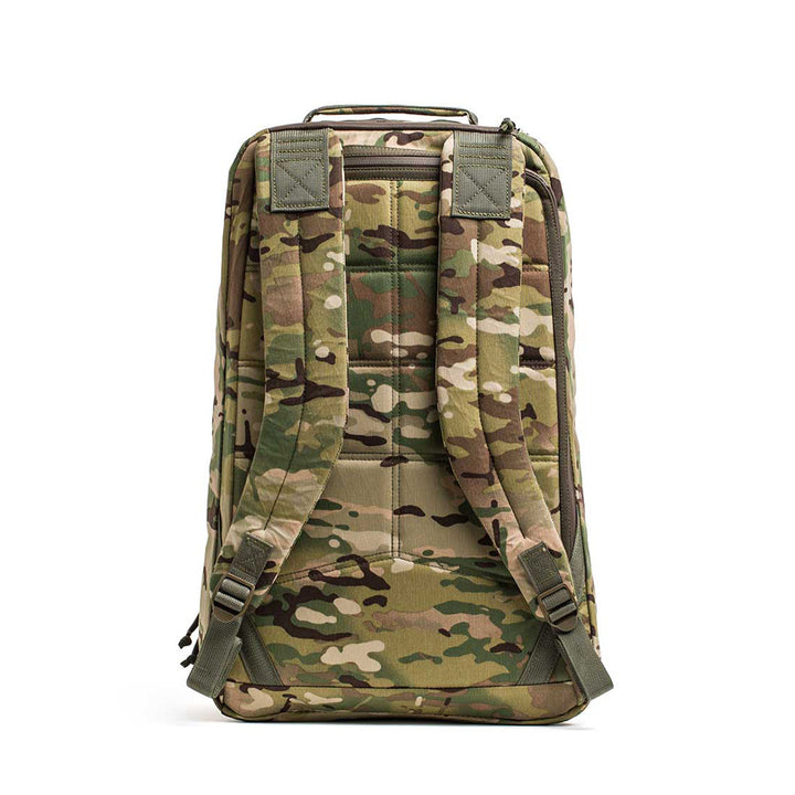 The GR1 USA - X-PAC rucksack comes in camouflage colors like green and brown. Designed for versatility, it features a waterproof fabric, dual shoulder straps, and a top handle for easy carrying.