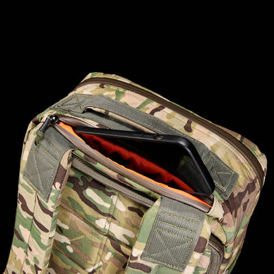 The GR1 USA - X-PAC rucksack is waterproof and features an open top zipper, revealing a bright orange X-PAC interior with a convenient phone compartment.