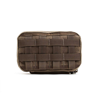 The GR1 Field Pocket - Waxed Canvas is a brown pouch crafted from durable waxed canvas with woven MOLLE webbing on the front, shown against a white background.