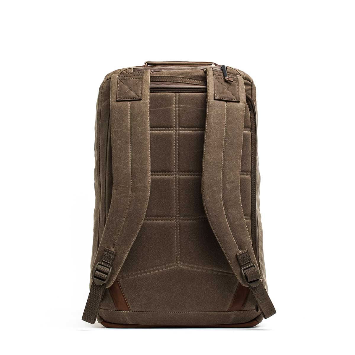 The GR2 - Heritage Waxed Canvas Backpack is shown from the back, featuring padded straps, a top zippered pocket, and is crafted from durable waxed duck canvas.