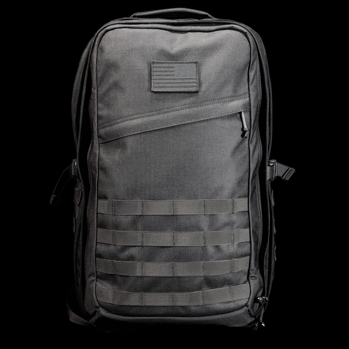 The GR2 USA Throwback is a black tactical travel backpack, crafted from rugged 1000D Cordura with MOLLE webbing and a small front patch, shown against a black background.