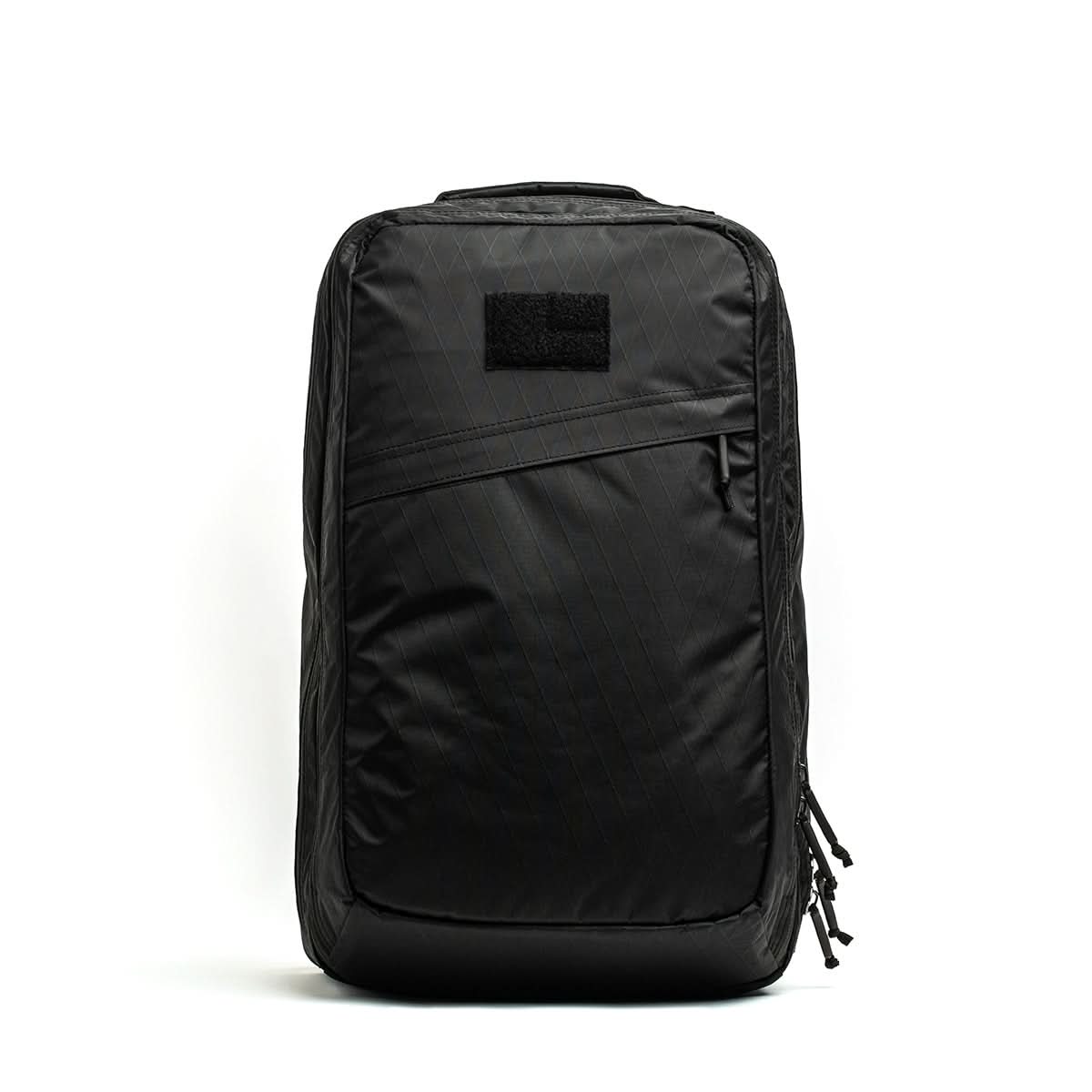 The GR2 X-PAC is a black, rectangular backpack featuring a diagonal AquaGuard zipper pocket, displayed against a plain white background.