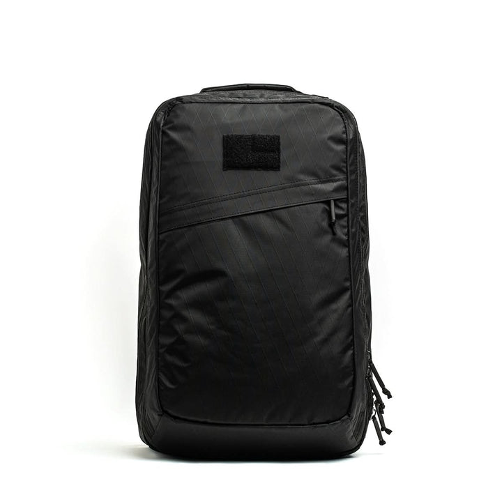 The GR2 X-PAC is a black, rectangular backpack featuring a diagonal AquaGuard zipper pocket, displayed against a plain white background.