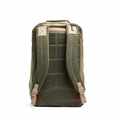 The GR2 - Waxed Canvas is an olive green backpack with tan straps, made from durable waxed duck canvas, shown from the back with padded shoulder straps and a top handle.