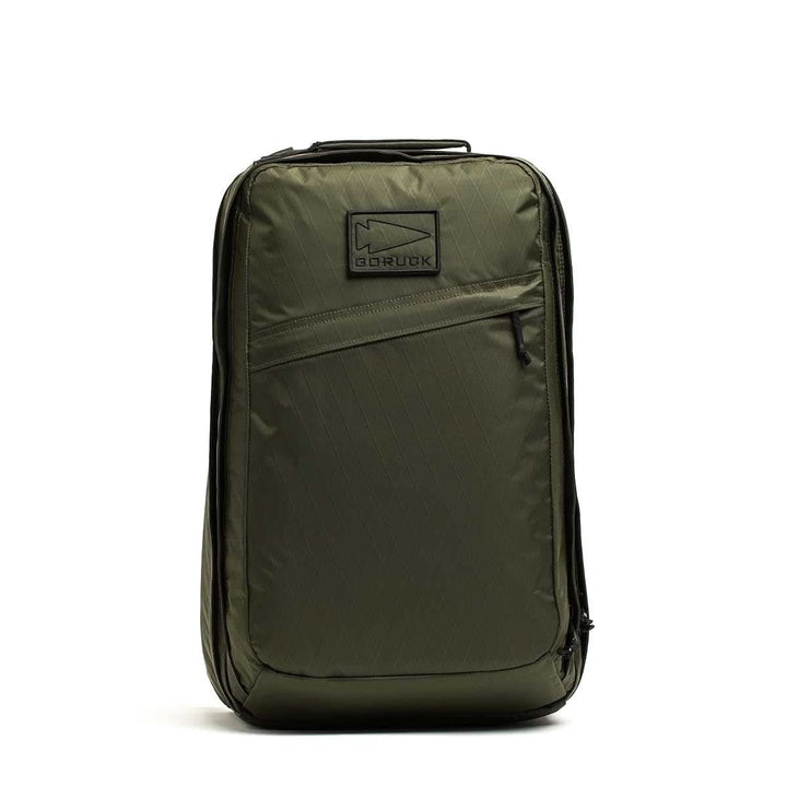 Olive green GR2 X-PAC backpack standing upright, featuring a front zipper pocket with AquaGuard zippers and a top handle.