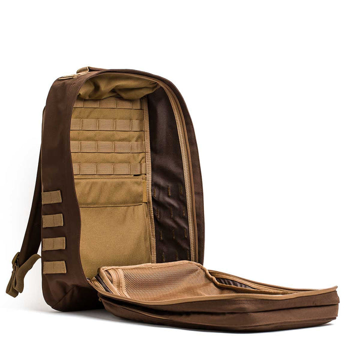 The GR2 - Ballistic Nylon Cordura travel bag stands upright unzipped, revealing organized interior pockets and compartments—ideal as a carry-on compliant ruck for your journeys.