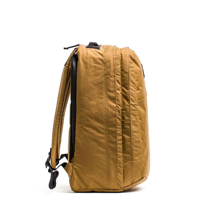 The GR2 X-PAC backpack, shown upright from the side, features black straps, a zipper pocket, and is made from durable waterproof X-PAC fabric.