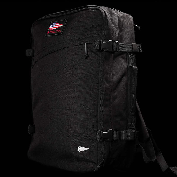 A sleek black GORUCK GR3 - Cordura carry-on rucksack showcases the GR3® logo above an American flag patch. It boasts water resistance, multiple straps, and a minimalist design.