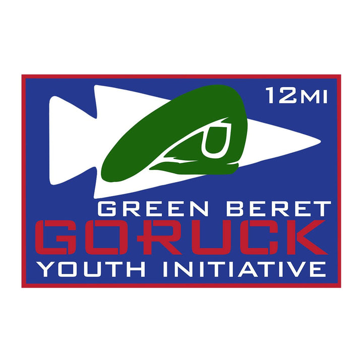 Blue and white badge featuring a green beret image, labeled "Green Beret GORUCK Youth Initiative 12mi." Patch for the Green Beret Youth Initiative Anti-Virtual Rucking Challenge youth event.