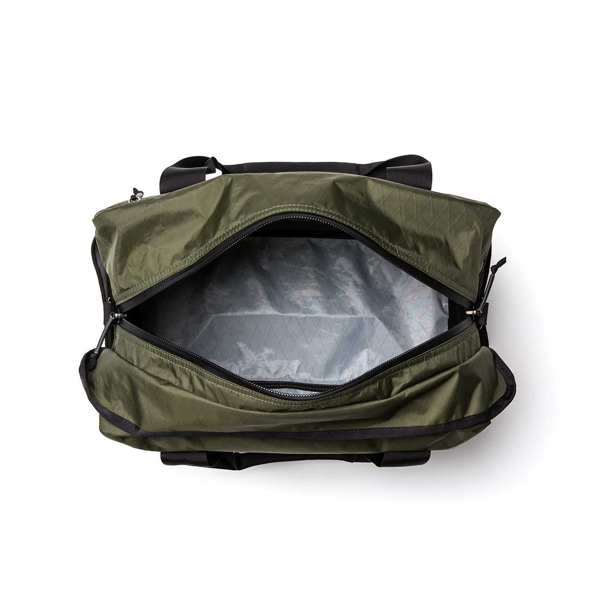 Olive green Kit Bag - X-PAC with black trim, unzipped to reveal a laptop inside the main compartment.