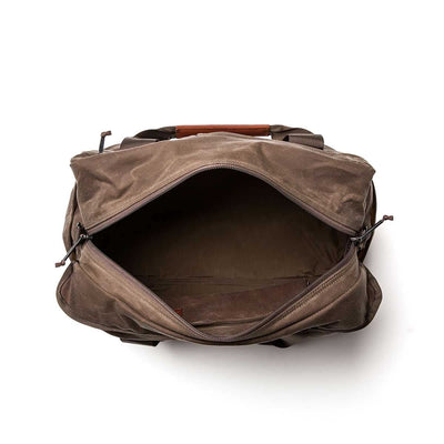 Waxed canvas aviator's kit bag featuring an open brown design, leather handle, spacious interior, and visible zippered opening.