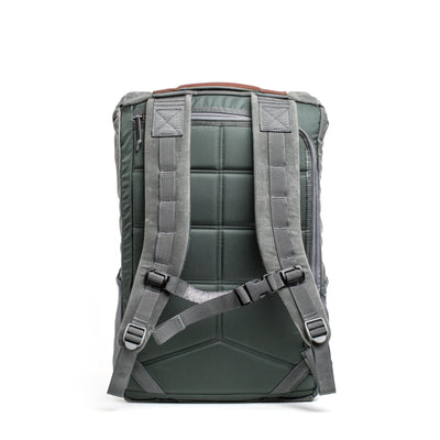Back view of the M24 - Waxed Canvas rucksack by GORUCK, showcasing durable materials with extra padded shoulder straps and a top handle, set against a white background.