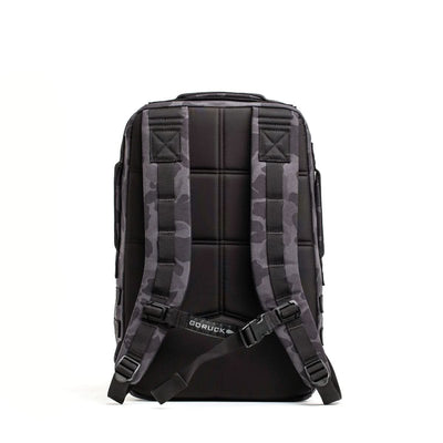The Rucker 4.0 backpack, shown from the back with camouflage-patterned straps against a white background, is a durable rucksack designed for rucking adventures.