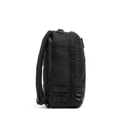 Radio Ruck USA Throwback backpack shown from the side, featuring padded straps, MOLLE-style webbing attachment points, and a bombproof laptop compartment for superior protection.