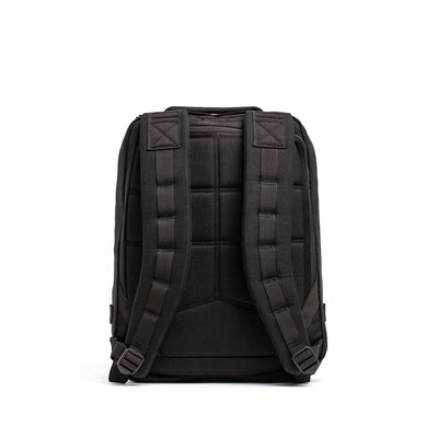 The Radio Ruck USA Throwback backpack is shown from the back with padded shoulder straps, a quilted design, and a bombproof laptop compartment inspired by Special Forces Radio Ruck packs, set against a white background.