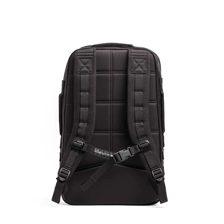 The GORUCK Rucker 4.0 backpack, in black, features ergonomic and padded shoulder straps along with a chest buckle. Its quilted back panel offers cushioned comfort for rucking adventures, while its durable and sleek design makes it ideal for everyday use or travel.