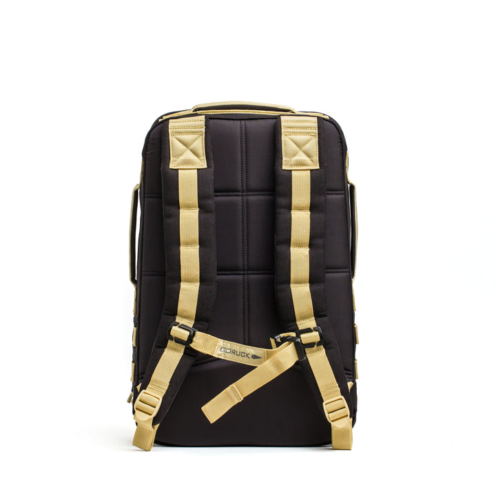 A Rucker 4.0 by GORUCK in black, featuring beige straps and a Rucker® logo on the back panel, set against a white background.