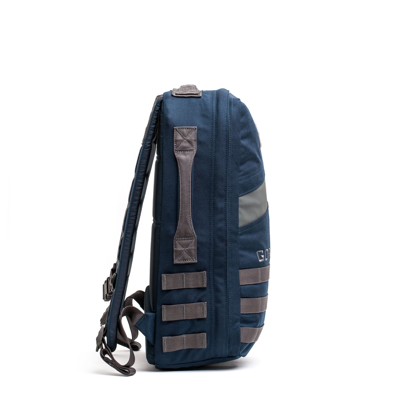 Side view of the Rucker 4.0, a blue rucksack with gray straps and webbing, standing upright on a white background—ideal for rucking or carrying ruck plates.